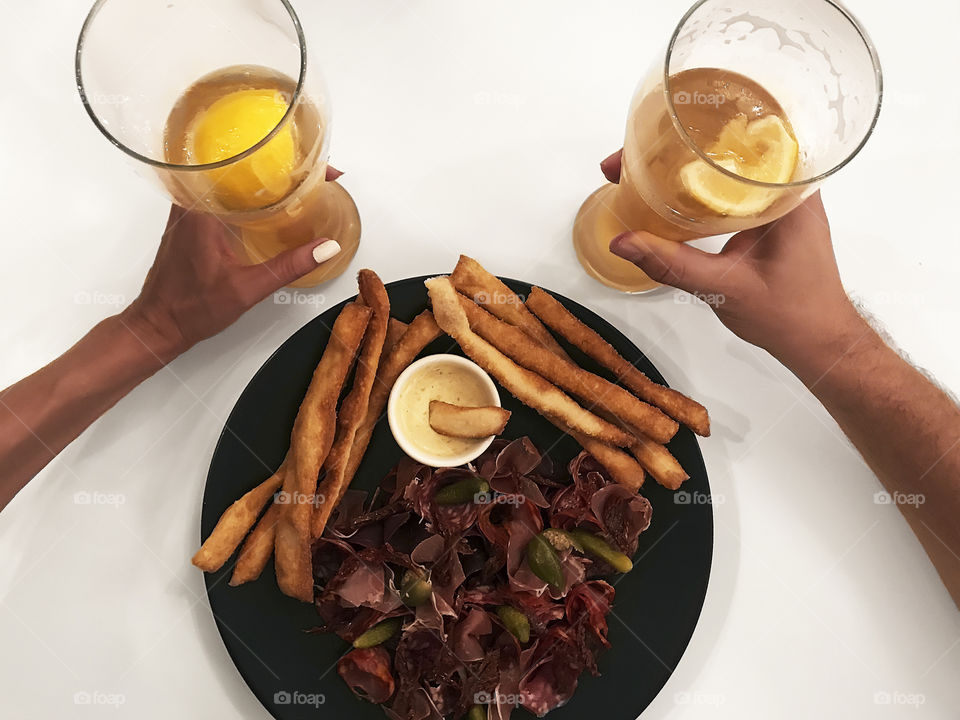 Glass of beer with lemon slice and yummy snacks 