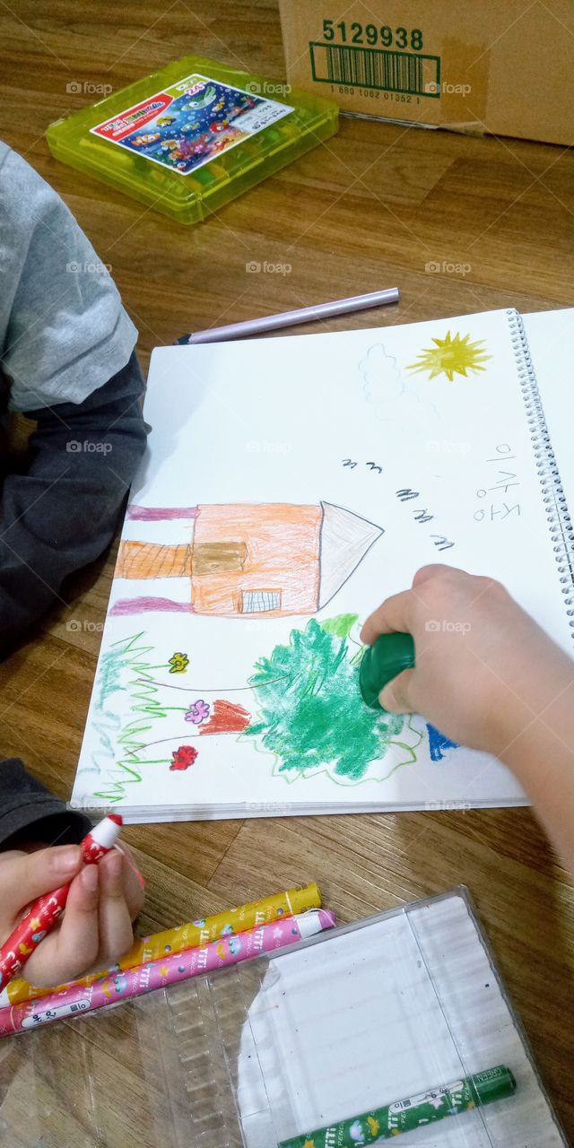 he draw a little house with a fine weather and a plants, trees and flowers beside it. 
this means his heart is happy, full of goodness and love.