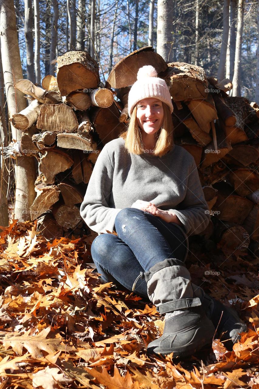 Autumn portrait by stacked wood.