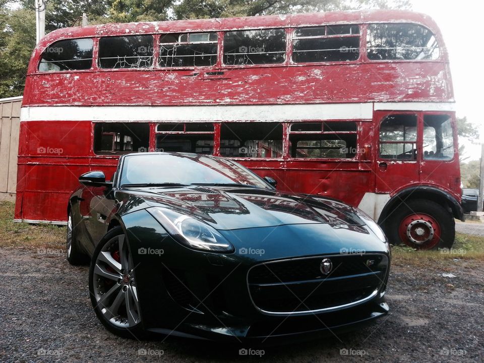 2014 Jaguar F-Type parked in front of double decker bus