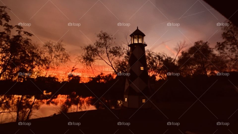 Lighthouse is lit Night is Approaching and the sky is blanketed with Enormous Colours. 