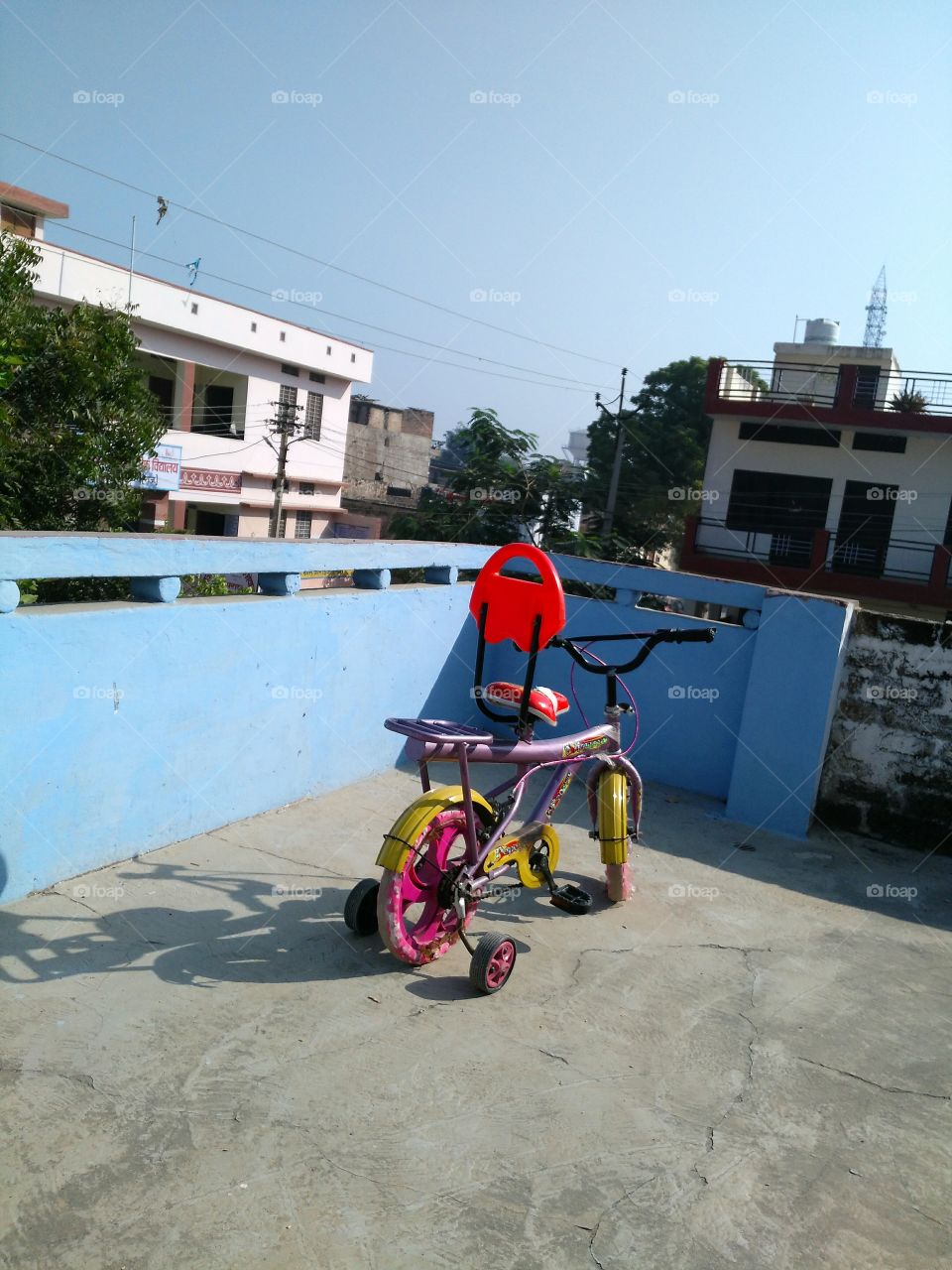 Bicycle with training wheels on terrace