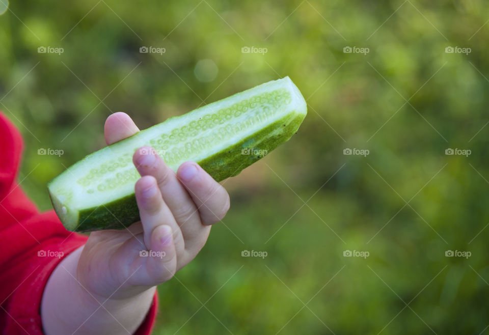 girl holding a cucumber