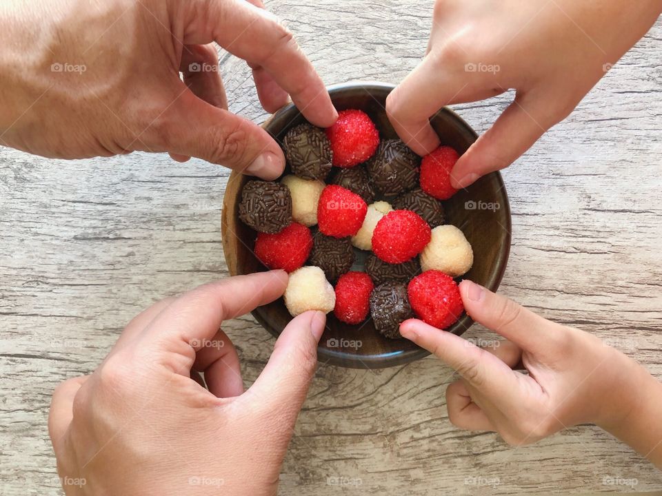 Strawberry, milk and chocolate candy (brigadeiro)