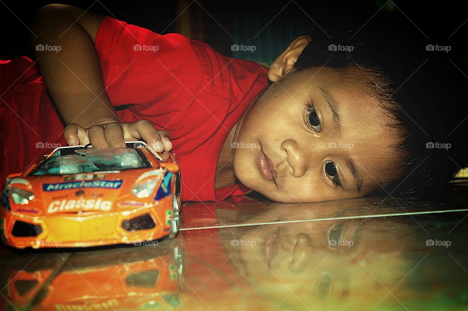 Boy playing with toy cars