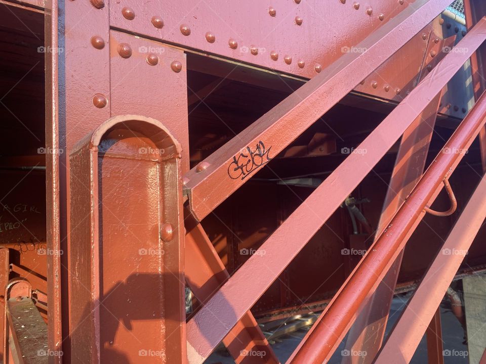 This structure in the industrial minimalist aesthetic that could easily be part of an art installation in a museum is actually a detail of the red metal staircase leading up or down the “Pulaski Bridge” in LIC, Queens. 2023 Hypnotic Productions
