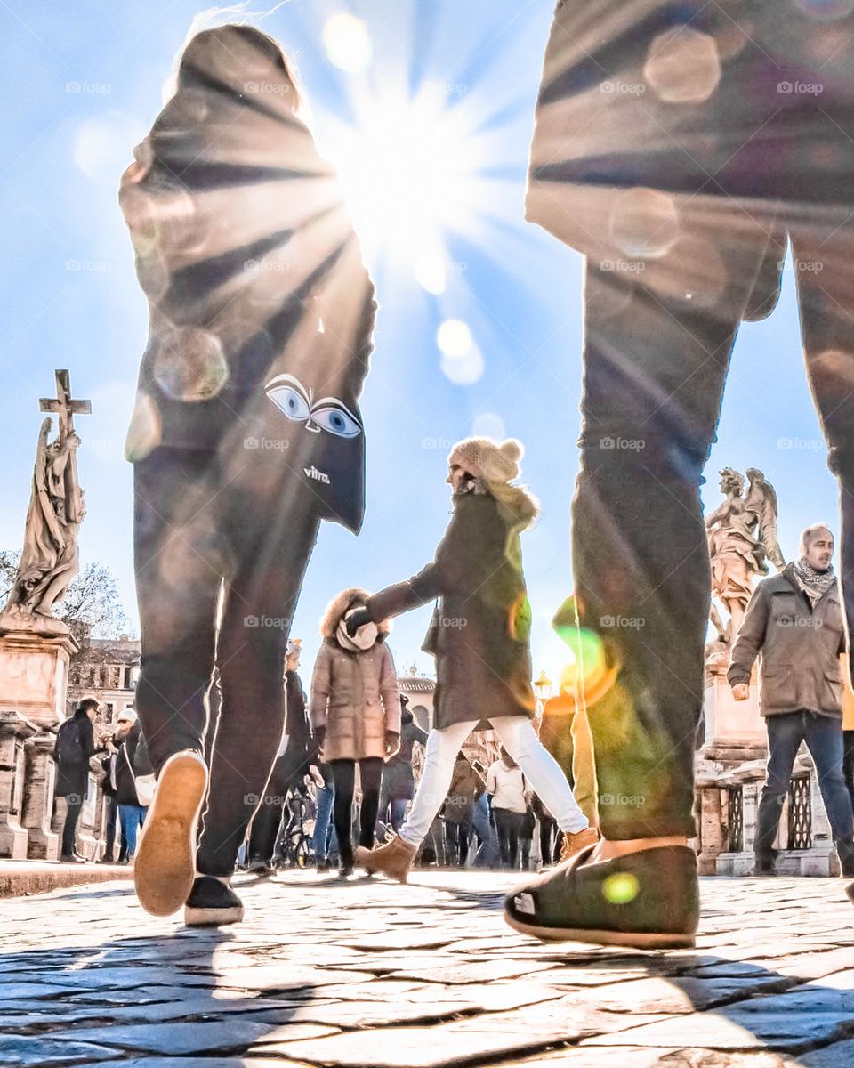 Crowd Of People Walking Under The Sun On City Busy Street