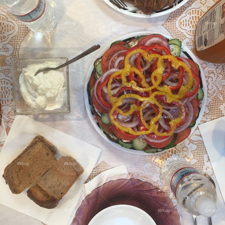 Healthy salad with butter on table