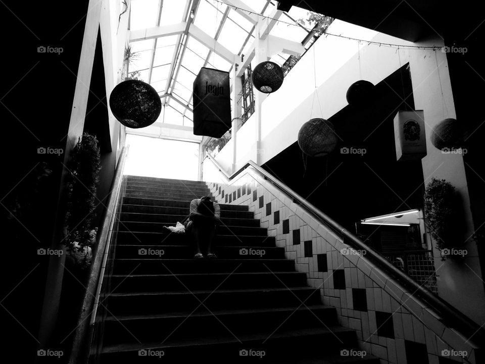 Sitting on the steps of the market