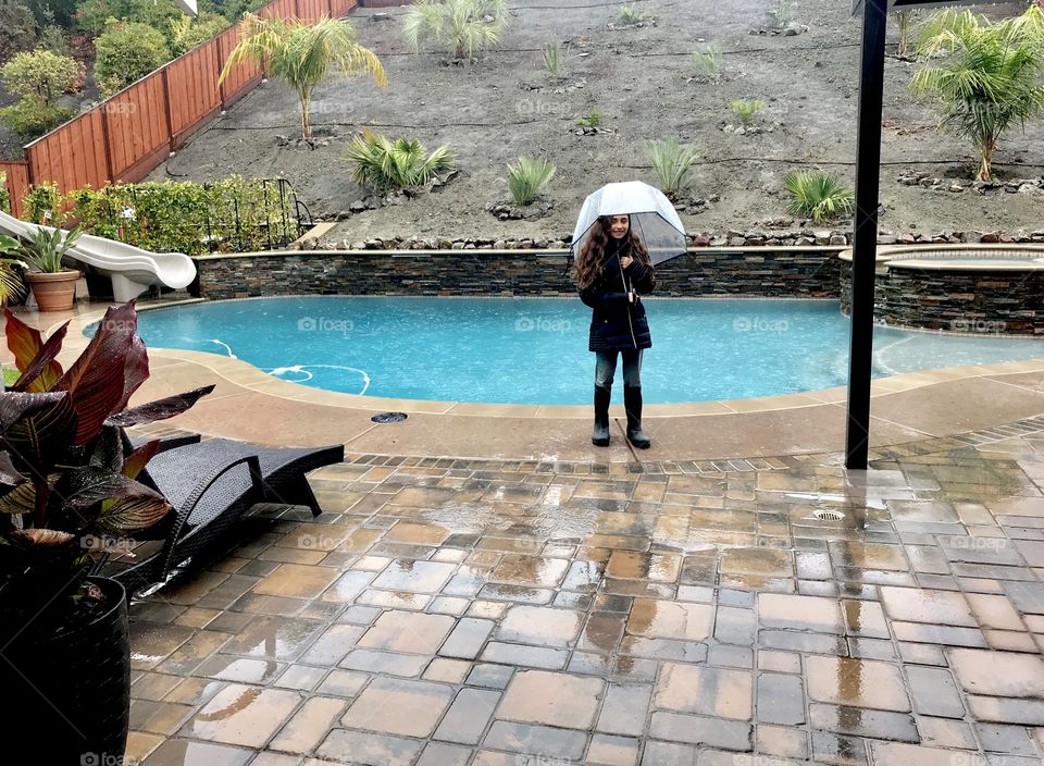 Ashley enjoying the rain in our backyard.