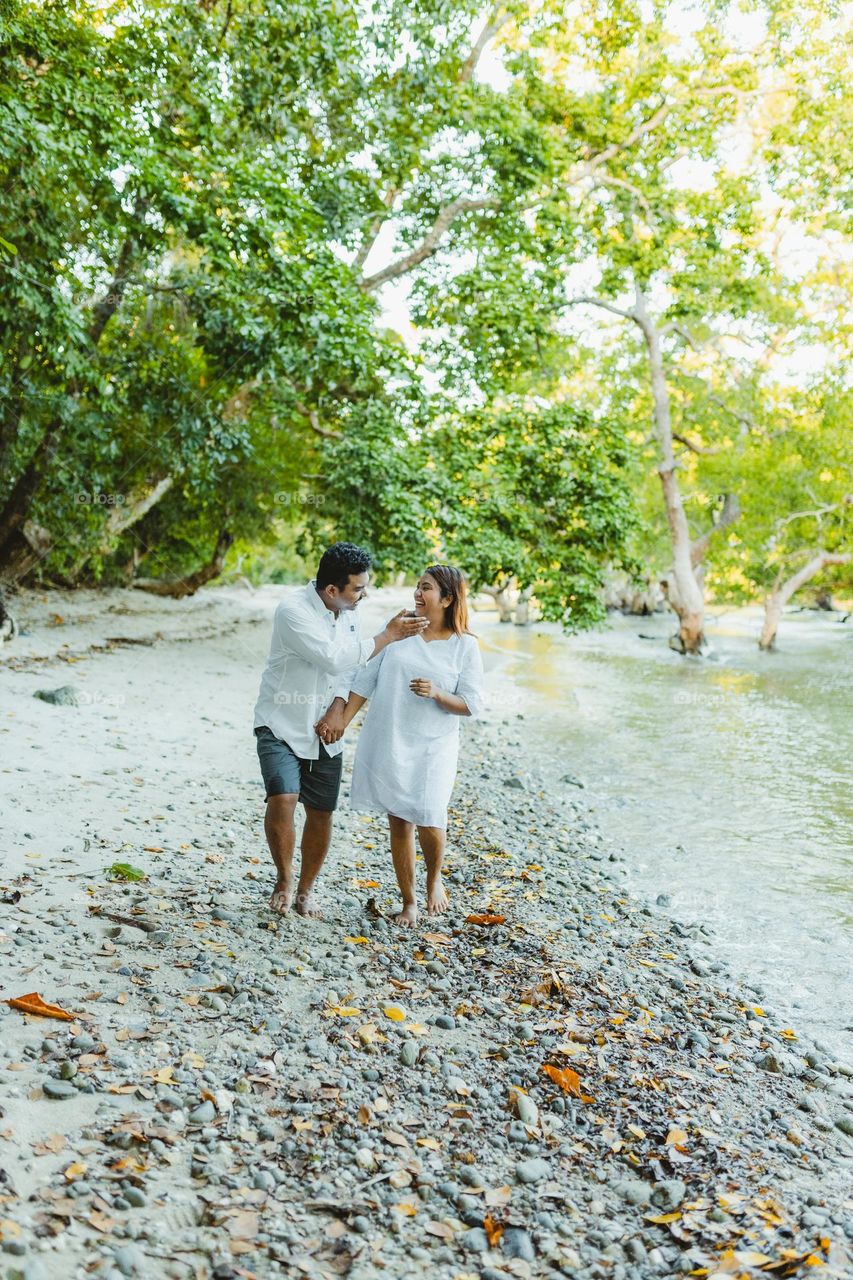 couple enjoying walking at the beach