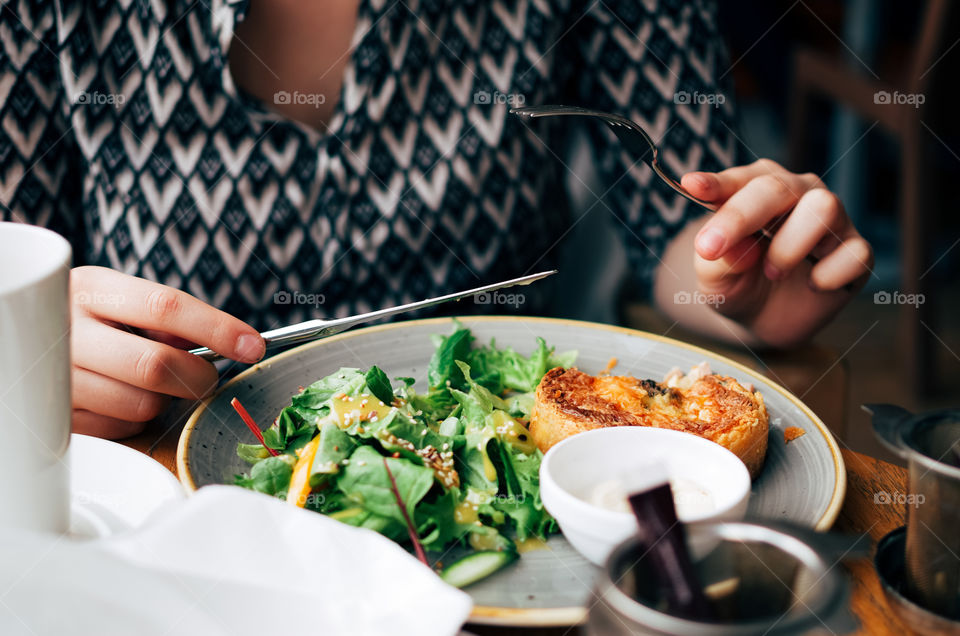 Closeup of a vibrant and colourful dish of quiche and a fresh salad.