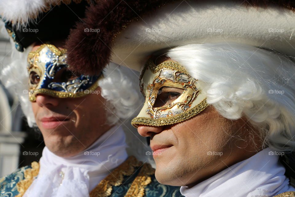 Two man wearing masquerade mask
