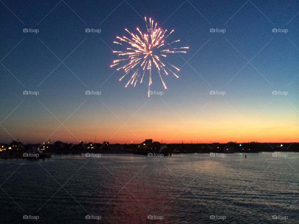 Fireworks over Ocean. Firework explodes over the ocean harbor at Galilee, RI