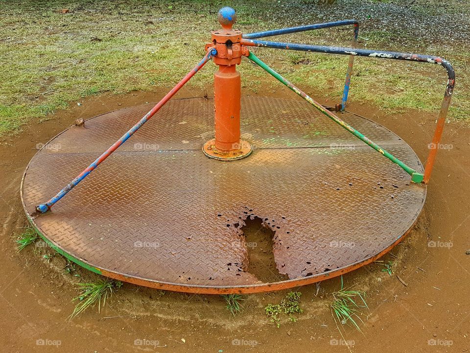 merry-go-round in public playgroud all rusted and broken