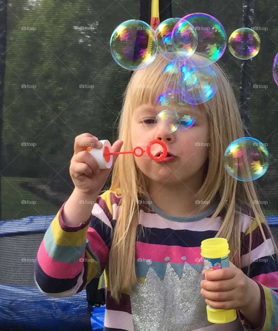 Blowing bubbles. 4 yearold girl blowing bubbles