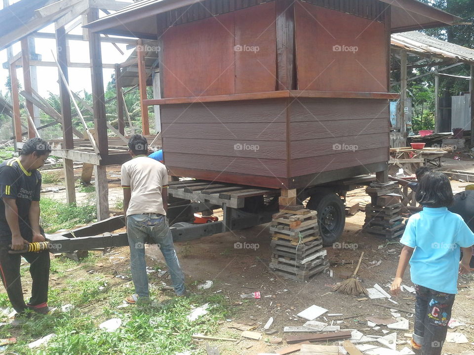 Thai carpenter working about tow wood coffee shop