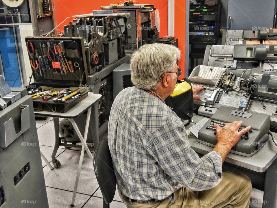 Elderly Man Volunteering To Restore Old Computers