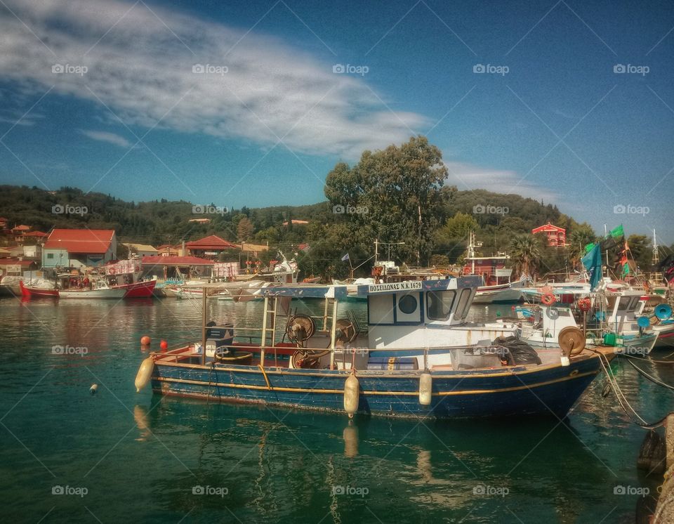 Corfu-Greece. Fishing boat in resting in harbour, on a sunny afternoon.