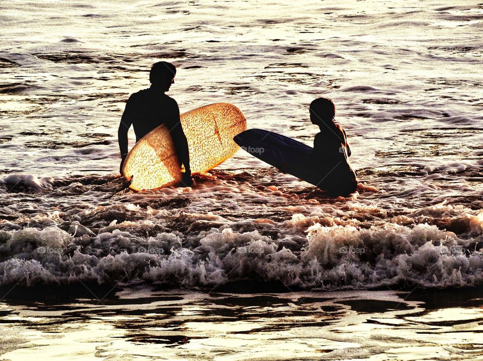 Father And Son Surfing In California 