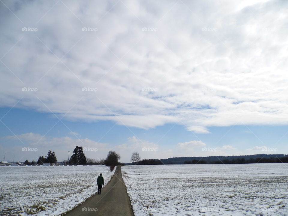 Man working alone on road in landscape and beautiful sky light and blue