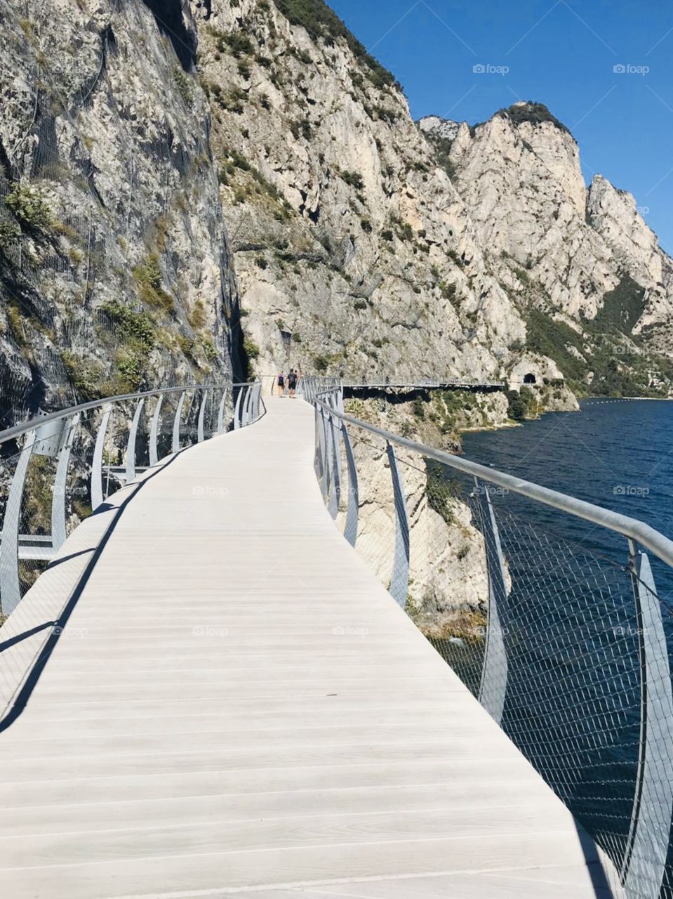 Panoramic bridge just on the cliff of the mountains, starting from Limone sul Garda and heading to Riva del Garda. Limone sul Grada, Lombardia, North Italy. Garda Lake.