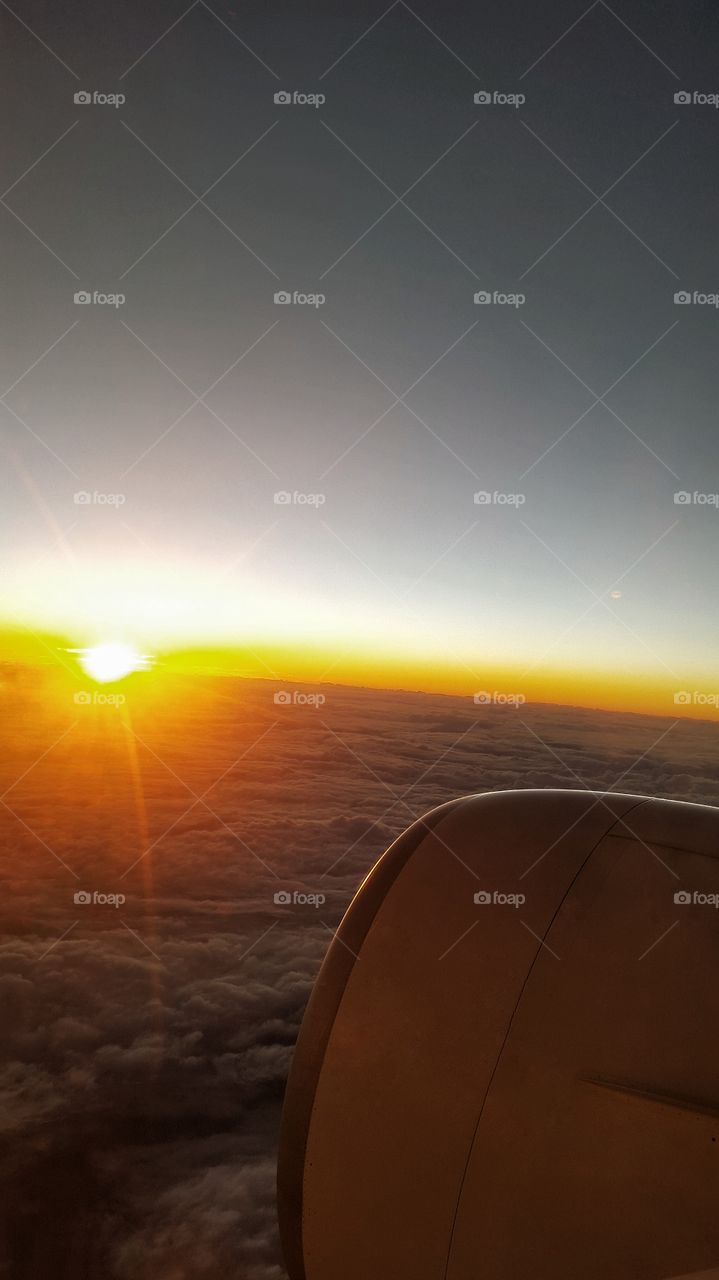 flying. flying on plane at sunrise