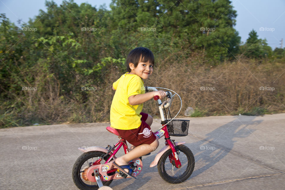 Young boy riding a bicycle. afternoon outdoor activity