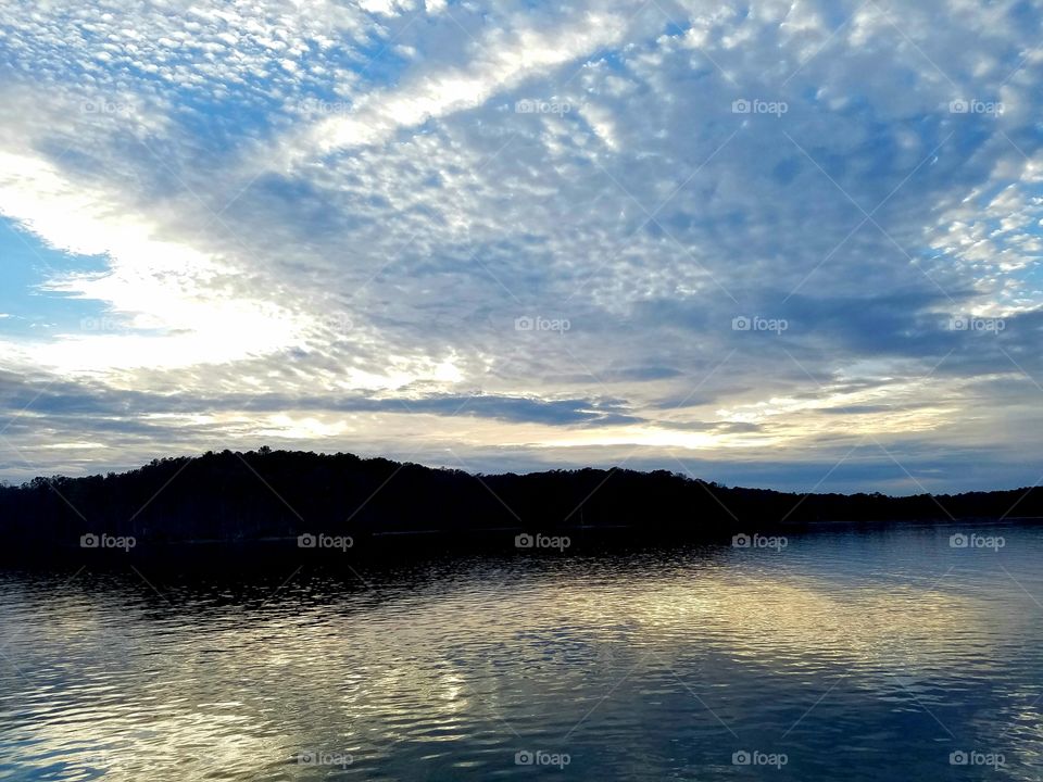 morning overlooking an island on a lake.