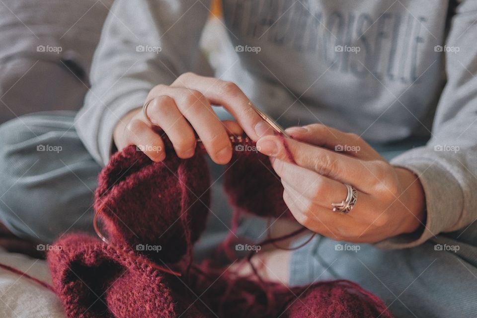Woman’s hands knitting sweater 
