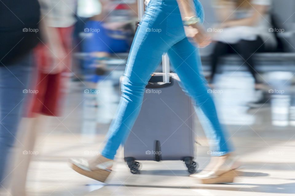 Woman rushing towards departure gate at the airport