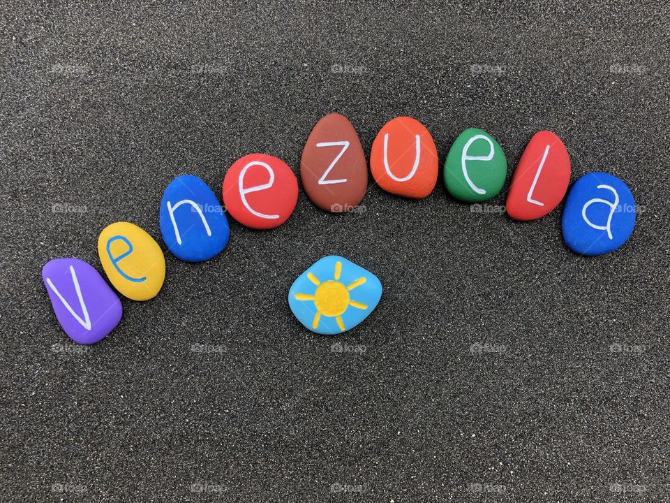 Venezuela, souvenir with multicolored stones over black volcanic sand