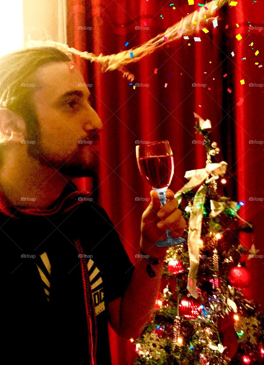 Beard man holding glass of wine in christmas