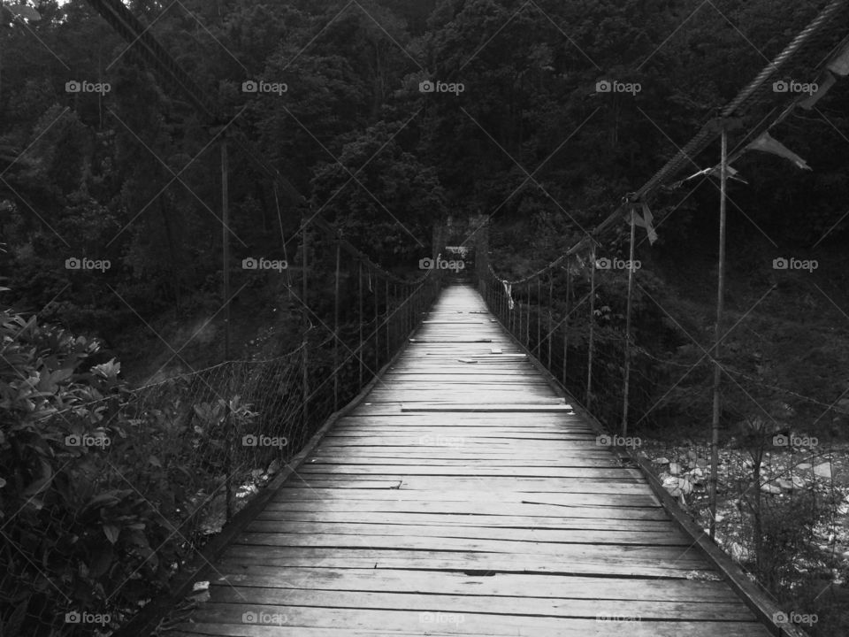 Wooden hanging bridge, between mountains.