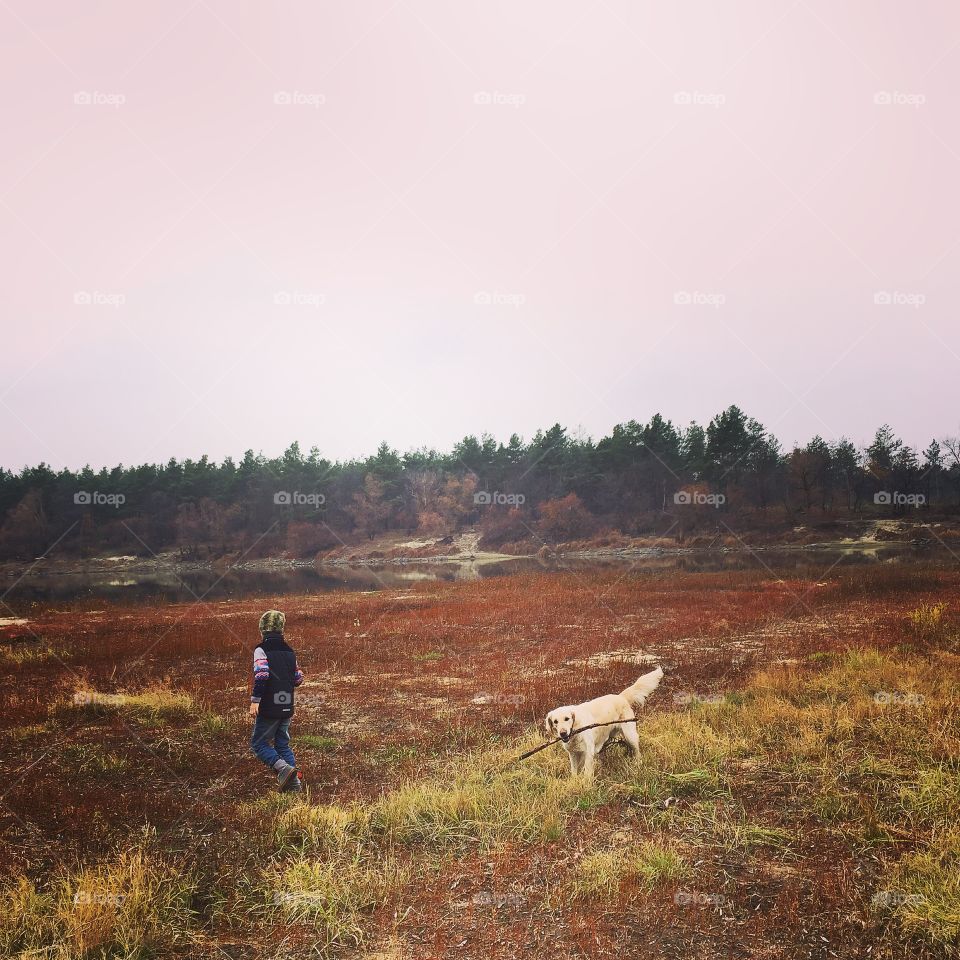 View of a person and dog in rural landscape