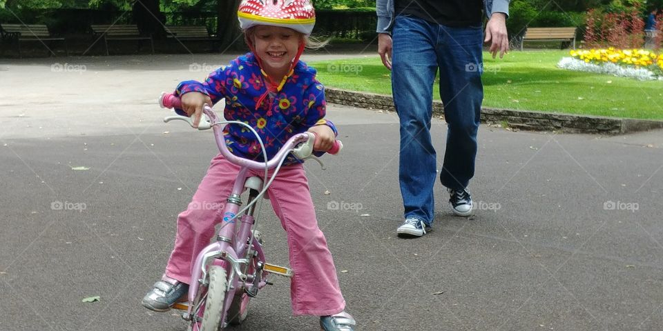 little girl riding bike for first time