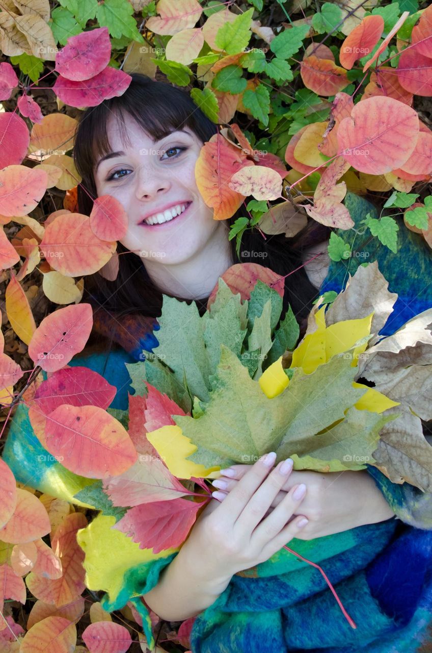 Portrait of a woman brunette on autumn background