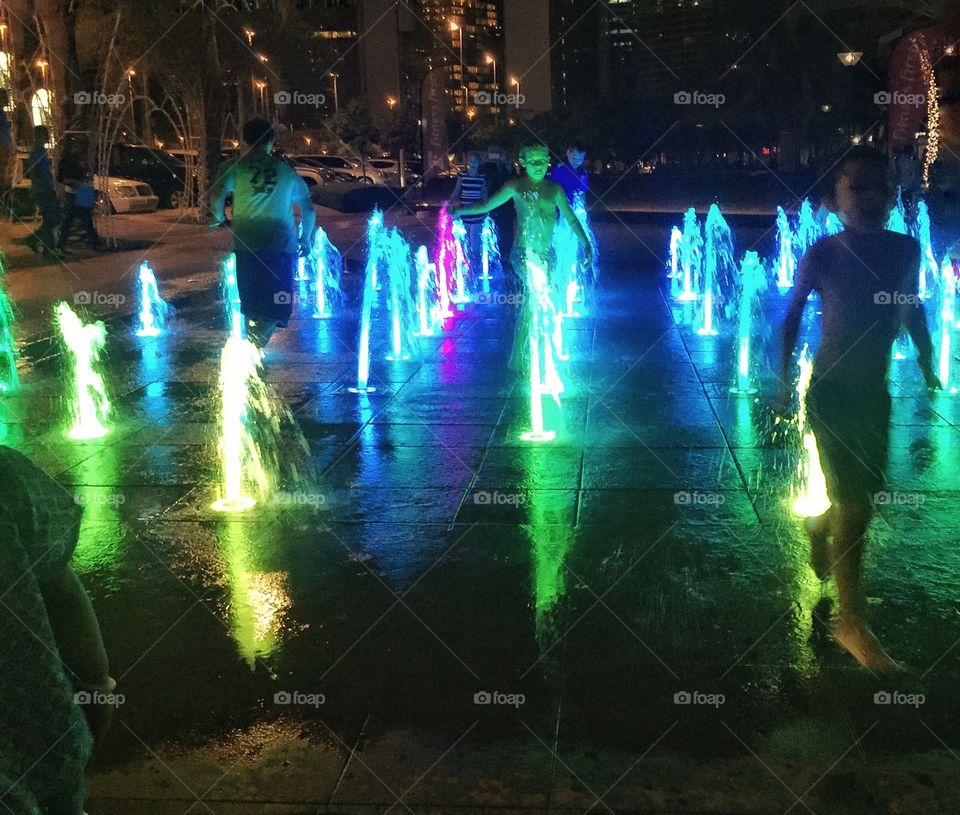 Children enjoying the colorful fountain