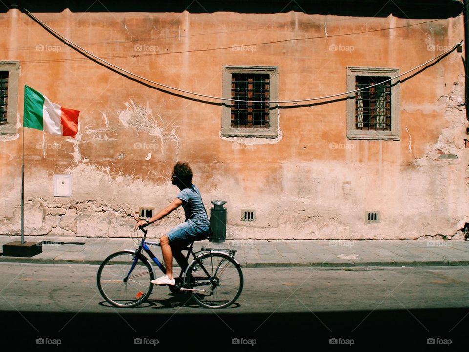 Man biking in Pisa, Italy
