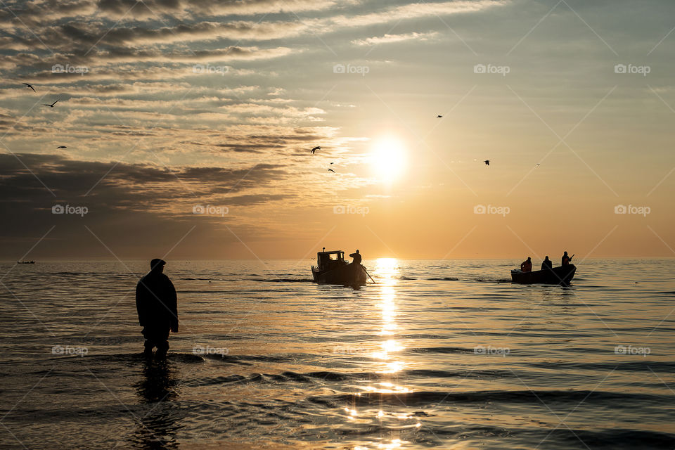 Seascape with fishermen returning from a morning fishing