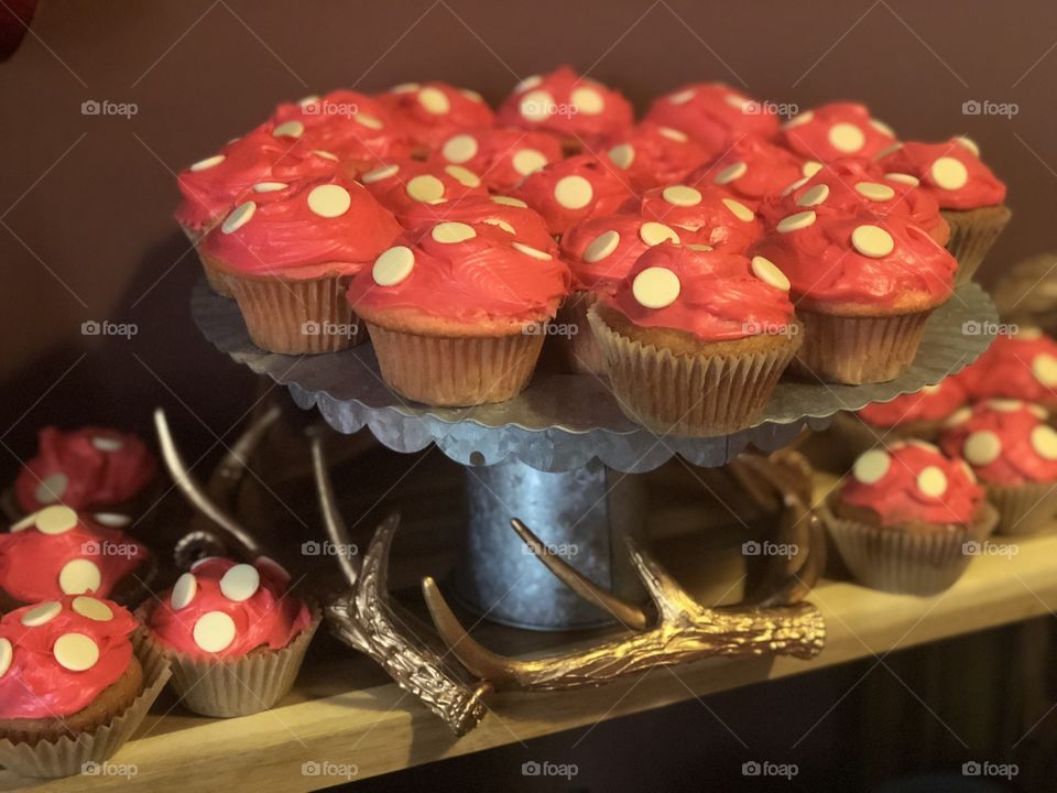 Mushrooms cupcakes on tin holders with golden horns 