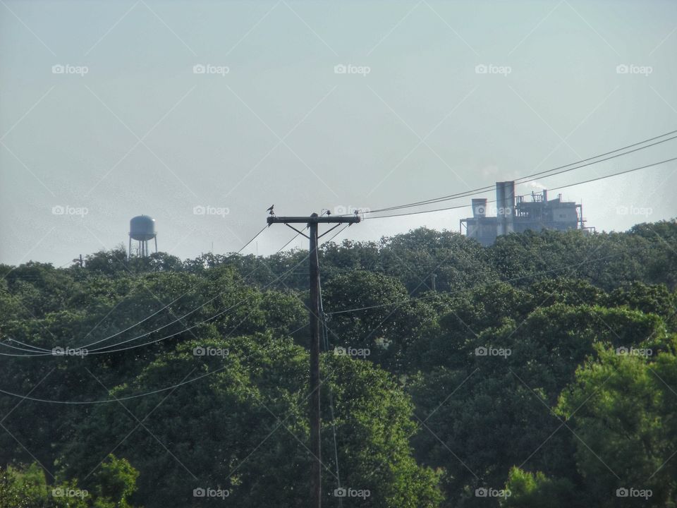 power plant 🌿 water 💦 tower. This is a picture of the local power plant 🌿 and the water 💦 tower 🗼 in the background