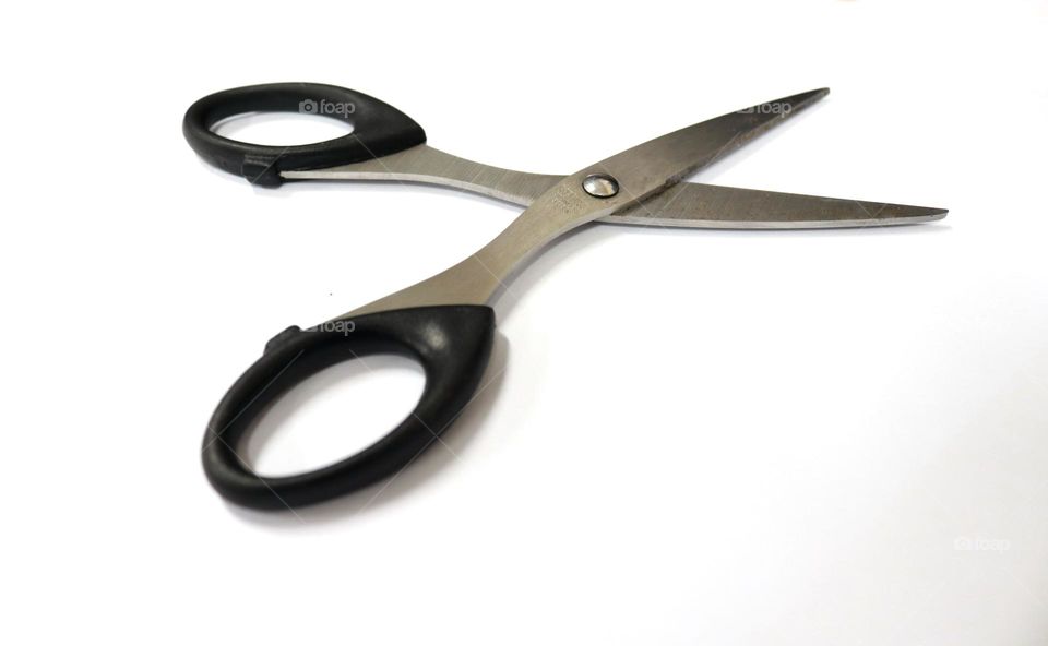 Photo of black scissors made of steel, this photo is on a white background