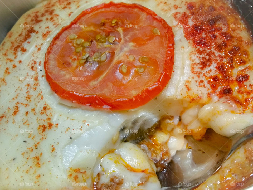 Moussaka with a tomato on  top