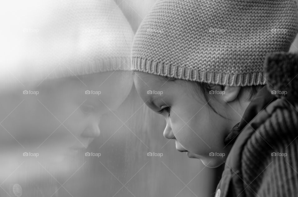 Baby girl reflected on glass