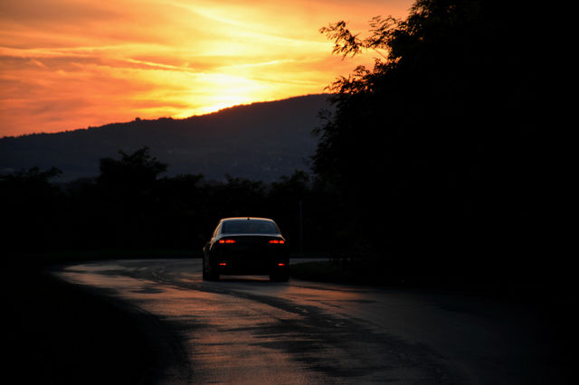 The car on the road to sunset
