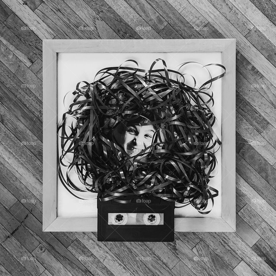 Woman face surrounded by cassette tape on photo frame