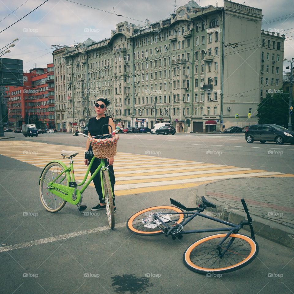 Two bicycles and cycling lady on one of the streets of Moscow, Russia