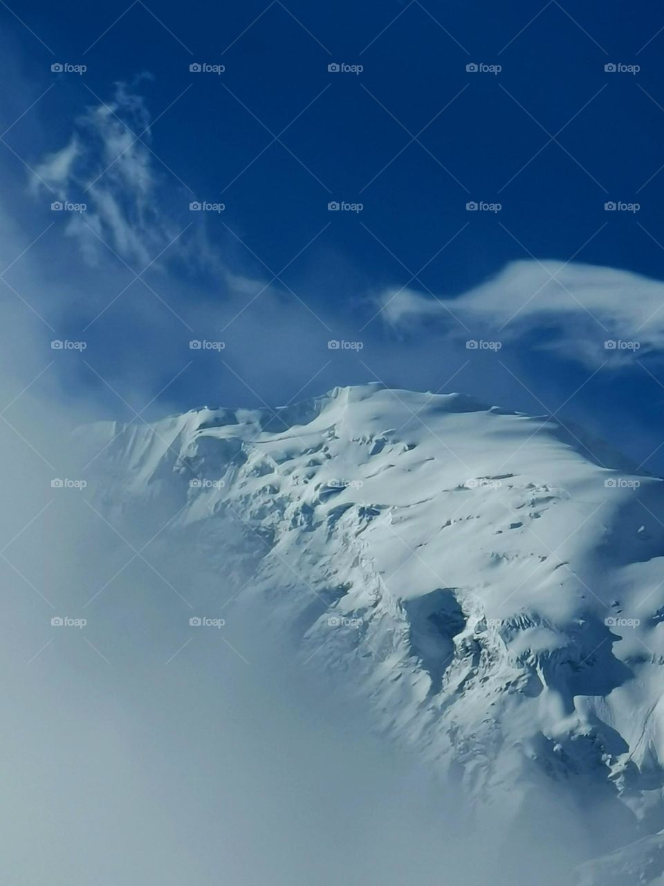 Clouds playing around peaks of himalayas