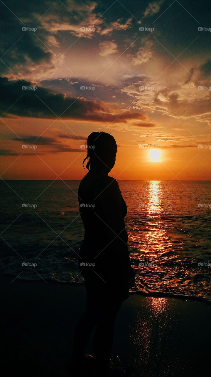 Woman silhouette against the sunset.